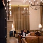 a couple lounges in the lobby of hotel teatro after their intimate wedding at the Denver clocktower