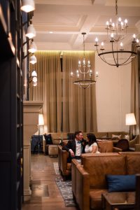 a couple lounges in the lobby of hotel teatro after their intimate wedding at the Denver clocktower