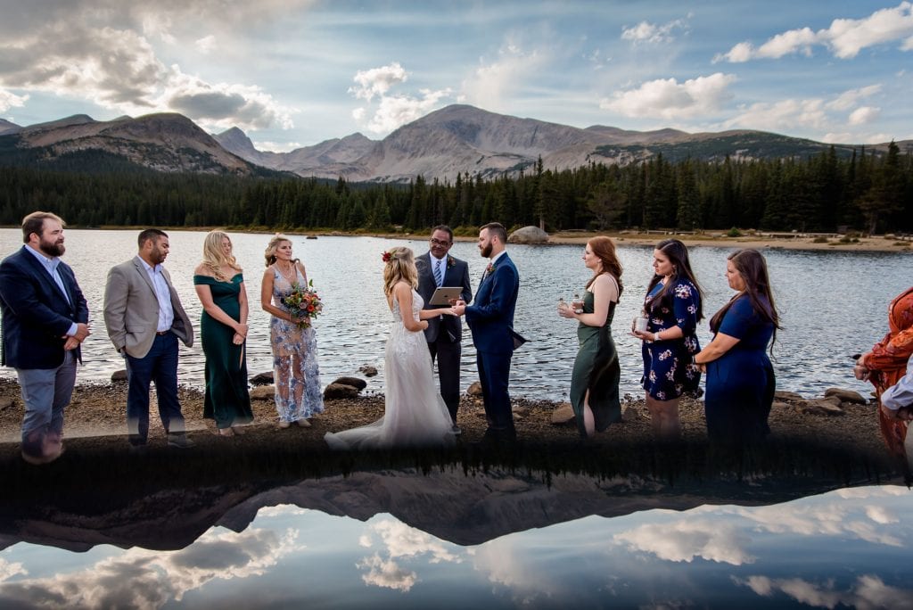 a couple elopes with family in front of Mt. Audubon in the Indian Peaks Wilderness