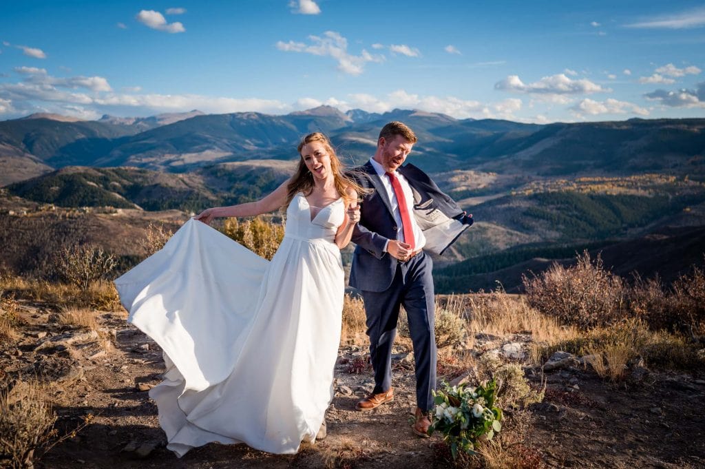after planning an epic elopement in Colorado a couple celebrates on top of a mountain