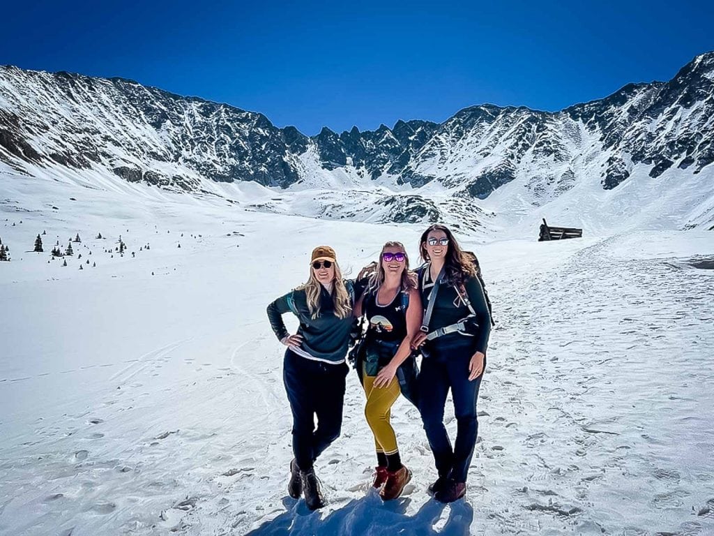 three girls celebrate a birthday in Mayflower Gulch after the hike up