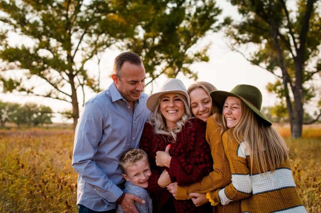 a family hugs their mama at the Fall family photoshoot in Denver, Colorado