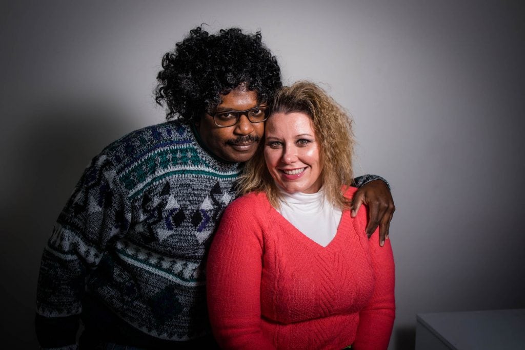 Couple poses awkwardly for their 80s styled engagement session in Denver, Colorado