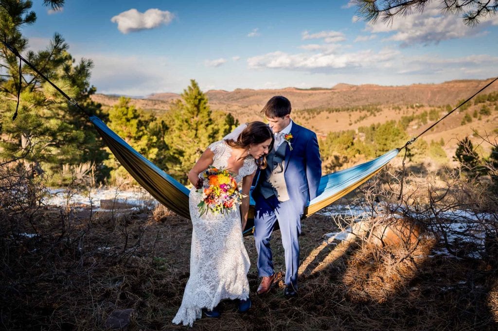 a couple relaxing in a hammock on their elopement day as a way to relax and take it all in