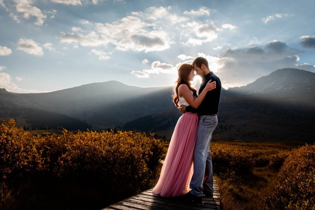 a couple snuggles in the first light of sunrise on Guanella Pass after their elopement