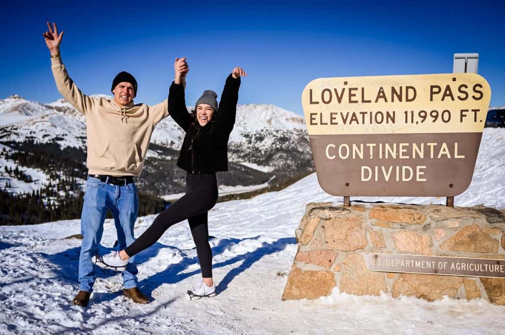 a couple celebrate their recent surprise proposal on top of loveland pass in Colorado