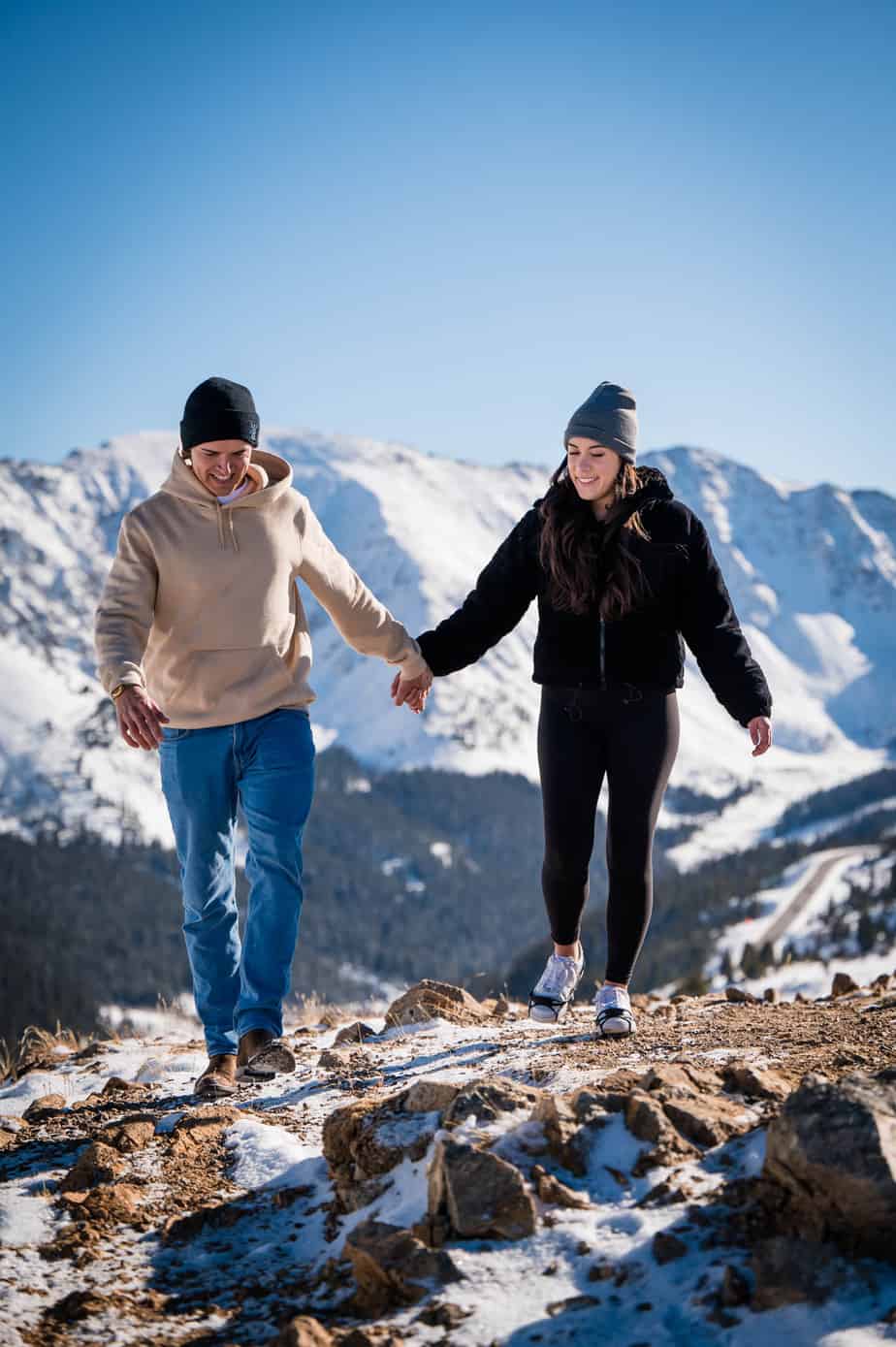 a couple hikes up on Loveland Pass together after their proposal at the ski area down below