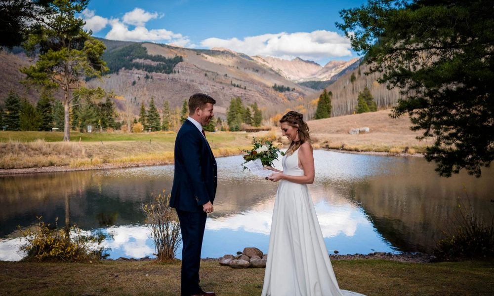 a couple shares vows on Vail's wedding island for their off season elopement in the Fall