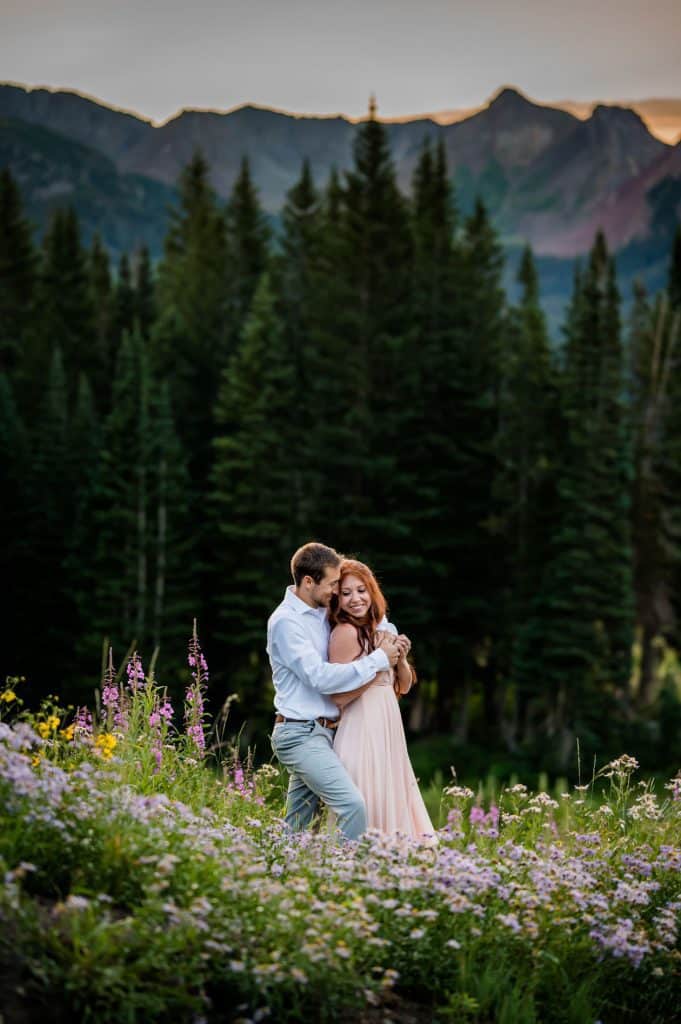 a couple snuggles up in the wildflowers on their elopement weekend in Crested Butte, Colorado