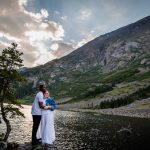 a couple stands on the shore of blue lakes in Breckenridge after their elopement ceremony