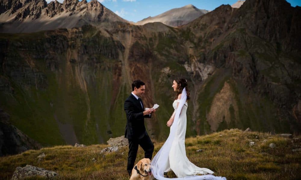 a couple reads their vows to each other at their 4x4 elopement in Yankee Boy Basin