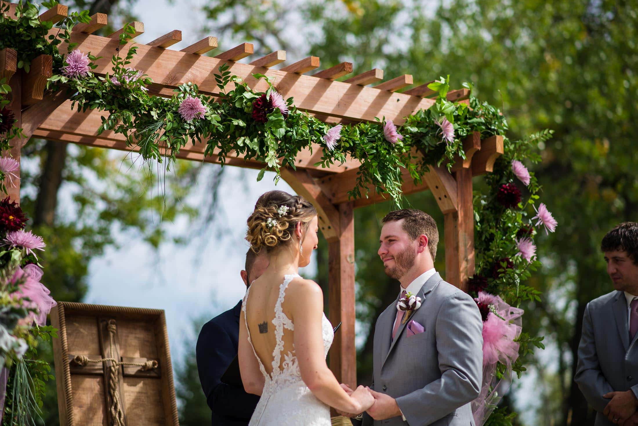 A couple says their vows to each other at their horse ranch wedding in Colorado. 