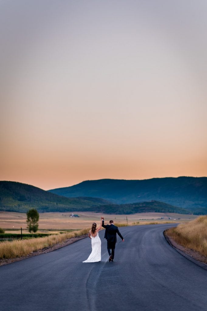 A couple dances in the road at their mountain wedding in Steamboat Springs Colorado