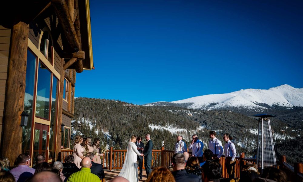 a couple exchanges vows at their mountain wedding in Colorado at the Lodge at Breckenridge