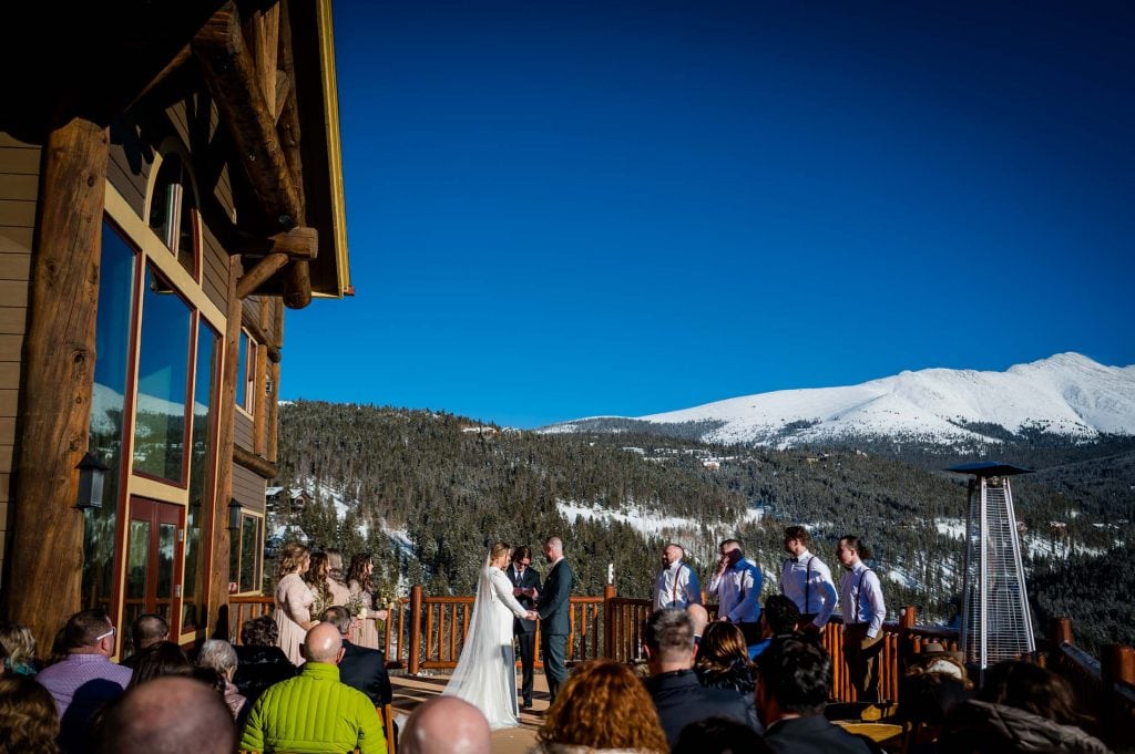 a couple exchanges vows at their mountain wedding in Colorado at the Lodge at Breckenridge