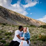 a couple snuggles on a mountain side near Blue Lakes in Breckenridge after their elopement wedding ceremony