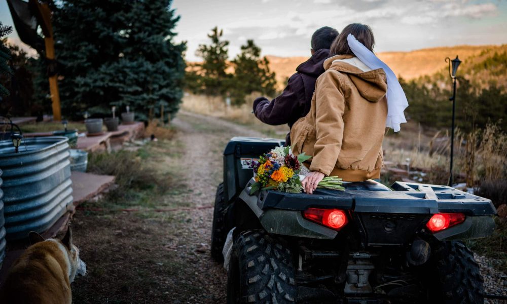 a couple rides their 4 wheeler on their private land near Lyons Colorado after their adventure elopement
