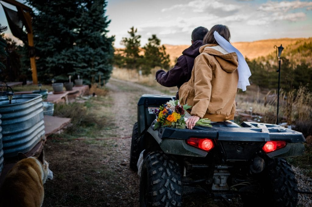 a couple rides their 4 wheeler on their private land near Lyons Colorado after their adventure elopement