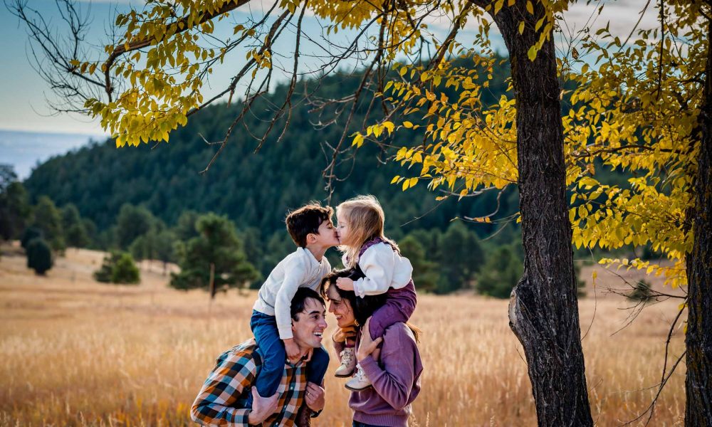 colorado family loving on each other at their candid photo session in the mountains