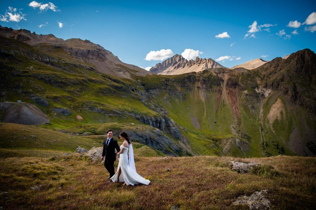 a couple walks hand in hand through Governor's Basin after their elopement ceremony in the San Juan Mountains