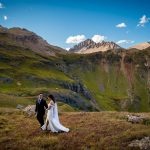 a couple walks hand in hand through Governor's Basin after their elopement ceremony in the San Juan Mountains