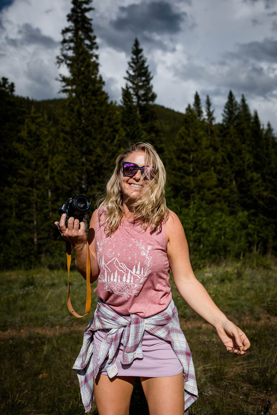 adventure elopement and mountain wedding photographer in Colorado, Nat Moore Photography, walks towards the camera