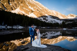 couple elopes on the shore of blue lakes in Breckenridge at sunrise