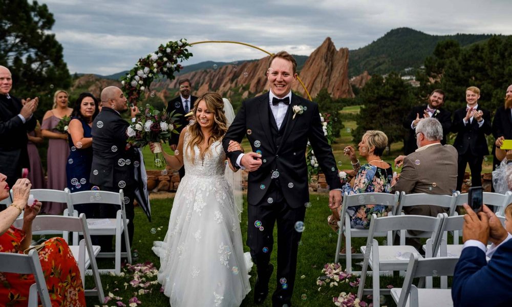 a couple has their bubble exit from their wedding at Arrowhead Golf Club in Colorado