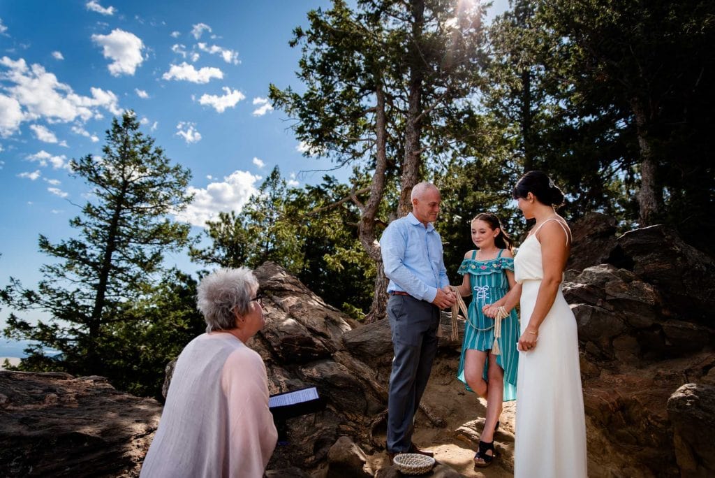 a couple elopes with only their daughter on the side of a mountain in Colorado