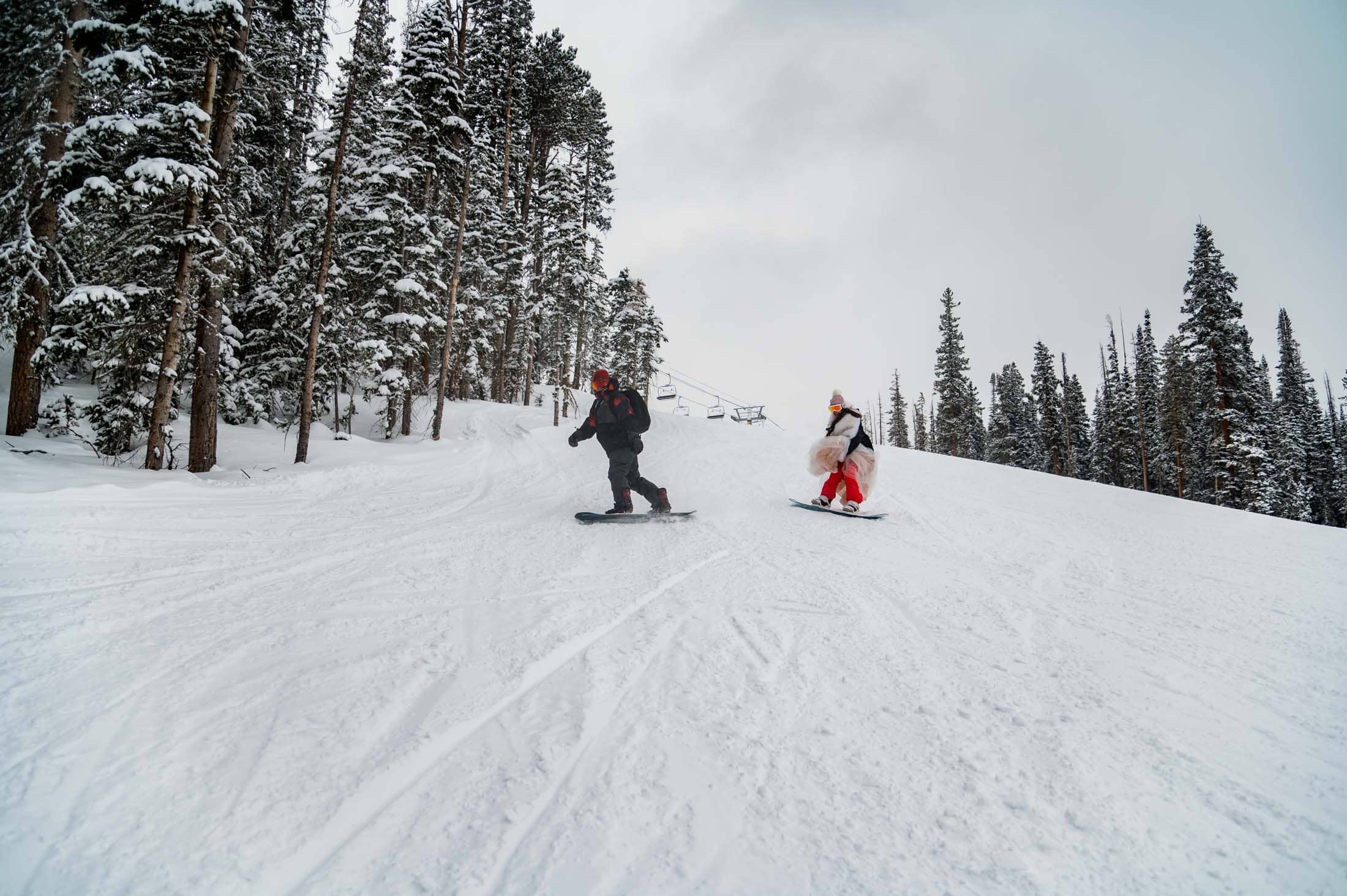 a couple snowboards at their elopement at Breckenridge