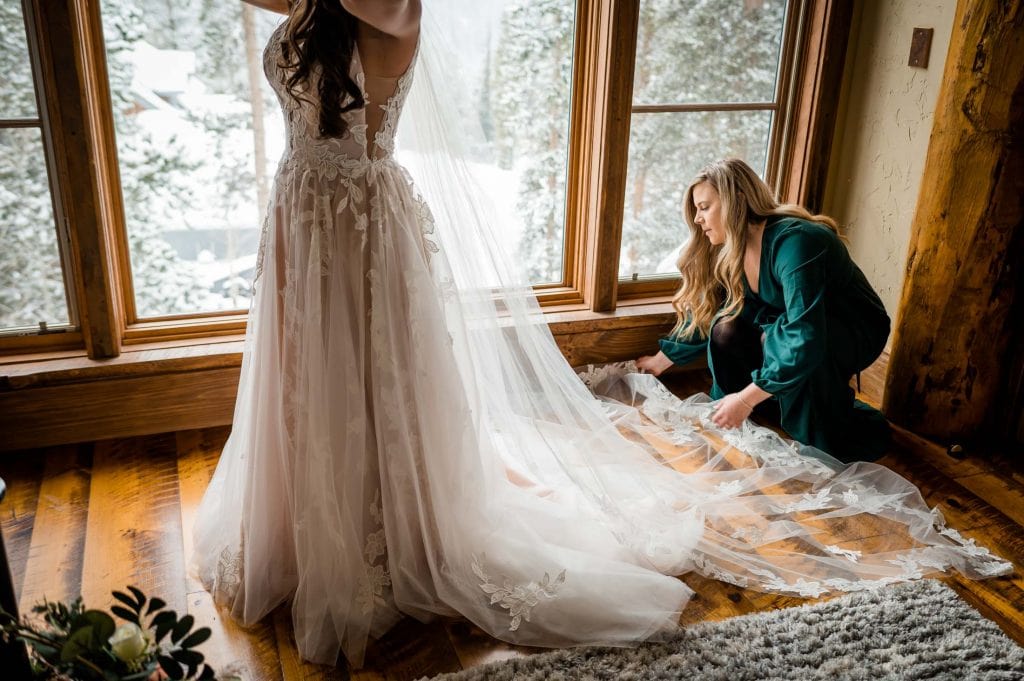 a bride's sister helps her get ready for her Colorado elopement in Breckenridge