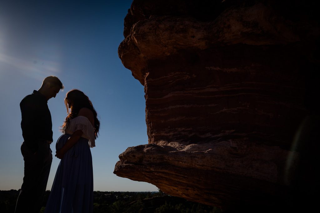 a couple adores their pregnant belly at their maternity session at garden of the gods in Colorado