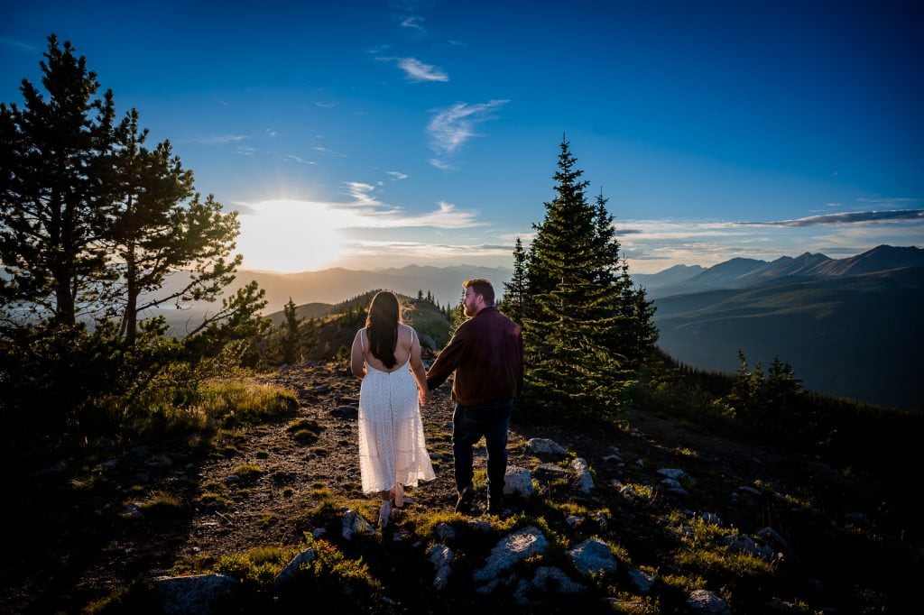 a couple hikes together on their elopement day during sunset in Colorado's Rocky Mountains