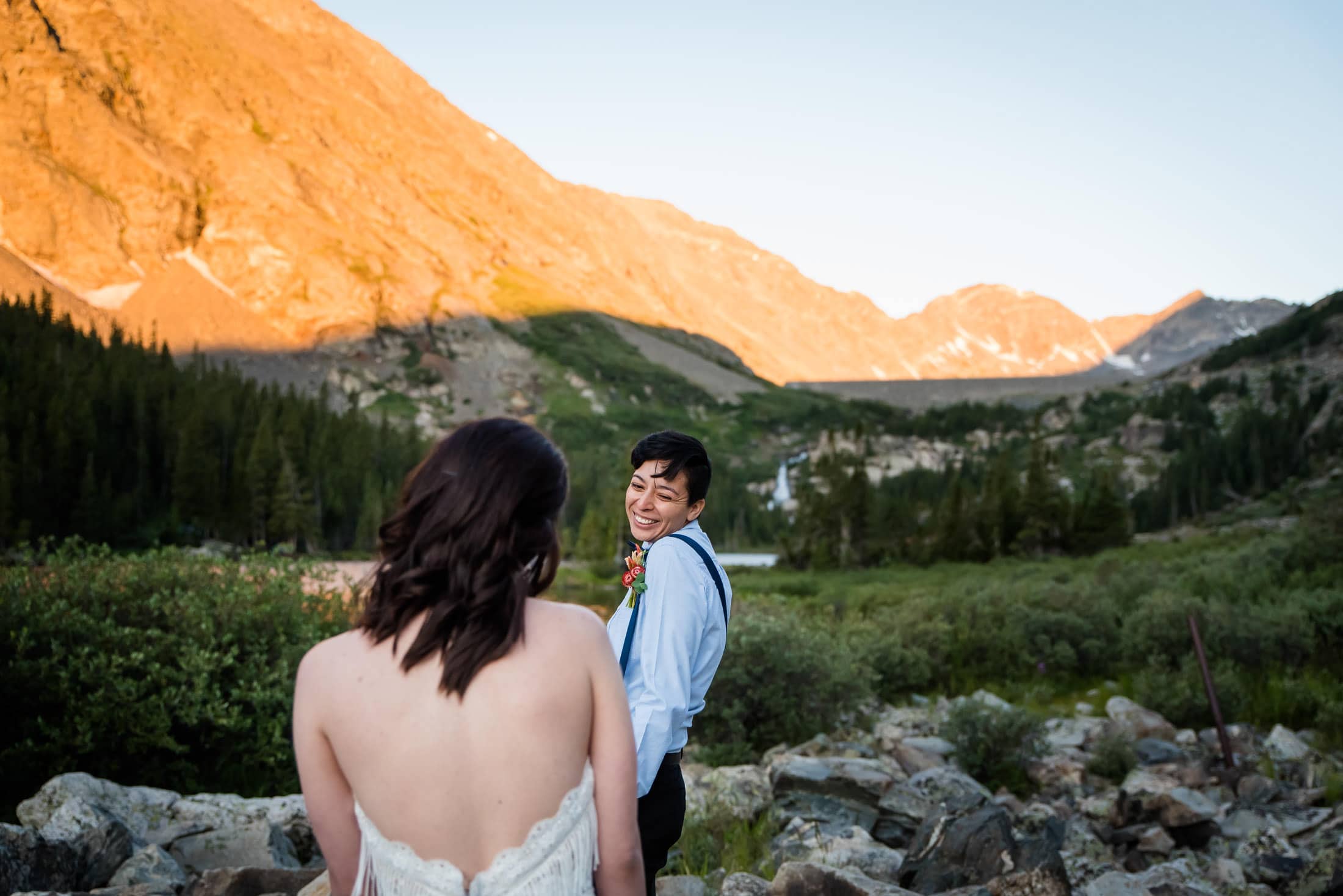 a marrying couple has their first look during alpenglow at sunrise in the mountains of Colorado before their elopement
