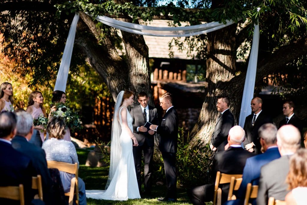 a couple shares their vows at Spruce Mountain Ranch in Colorado