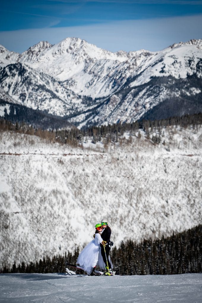 a couple poses on the slopes of Vail resort at their ski elopement