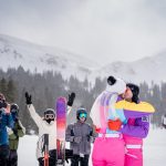 a couple shares their first kiss at their slopeside ski wedding at Loveland Ski Area