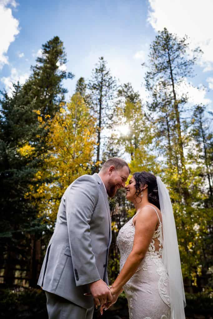 a couple stares lovingly into each other's eyes at their fall elopement in Colorado