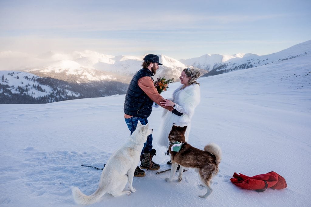 a couple shares vows atop Loveland Pass with their dogs before heading to Arapahoe Basin to take a few first laps!
