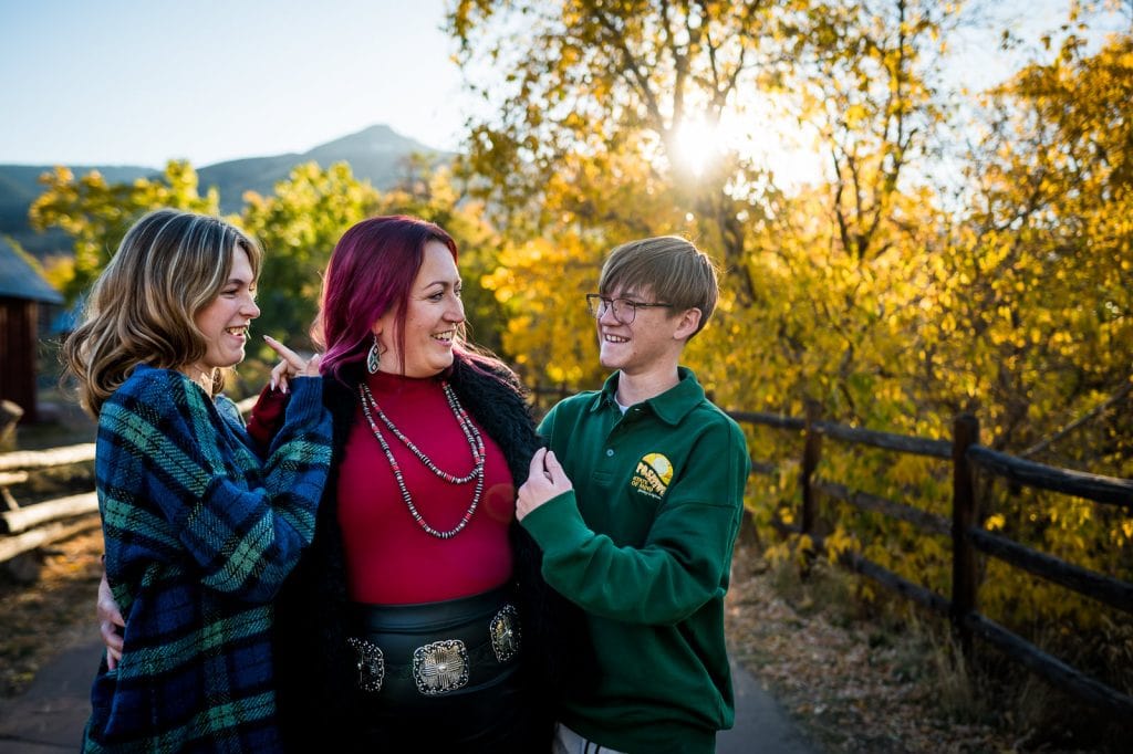 a family laughs at each other during their family photos portion of the daughter's high school senior session