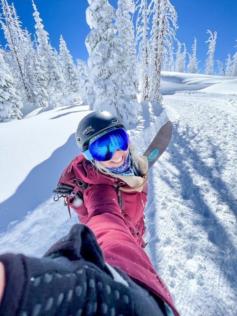 Nat Moore Photography hiking in a white winter wonderland with her snowboard at Wolf Creek Ski Area