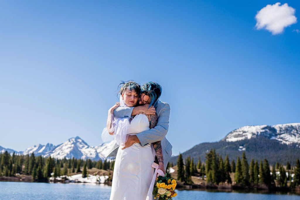 a couple embraces near Molas Lakes during their Colorado adventure elopement