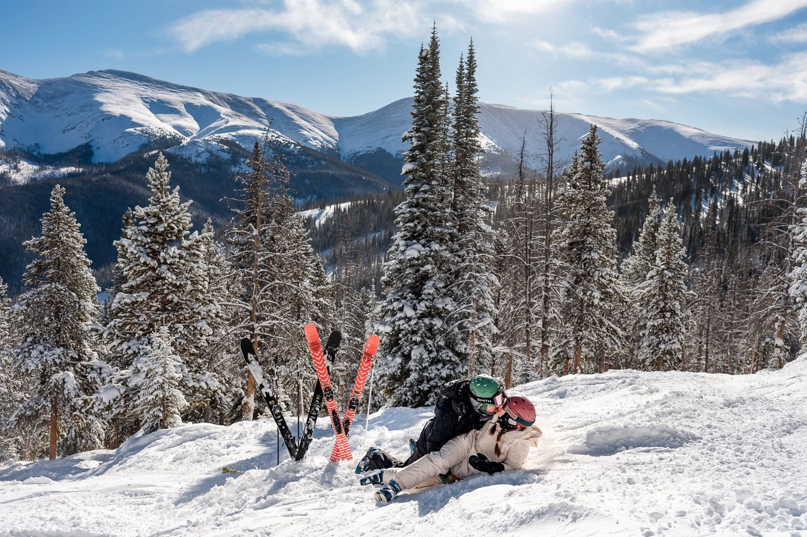 A couple plays in the snow at their Winter Park Ski Elopement