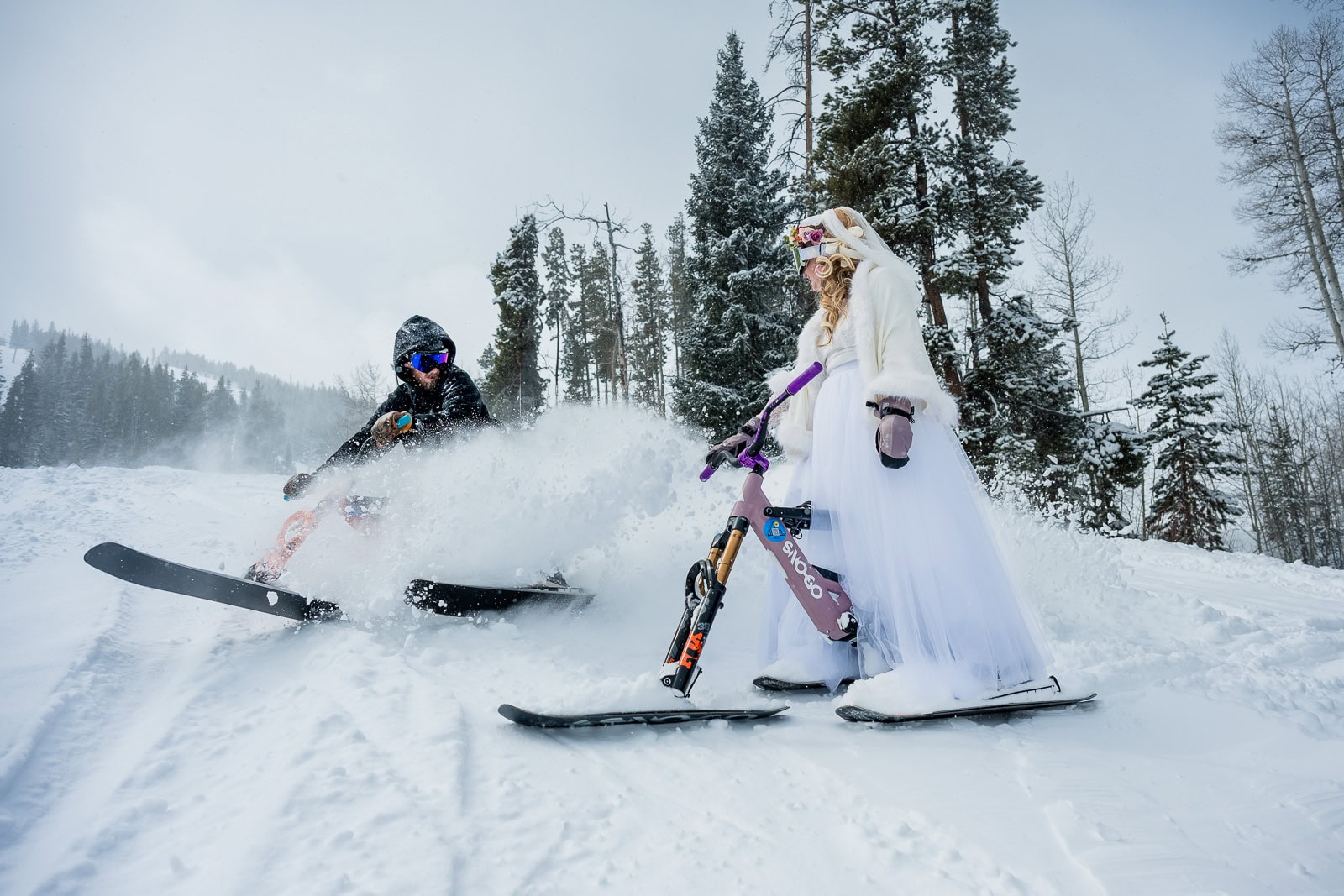 a groom skies up to his bride and sprays her with powder on a run after their vow exchange at Beaver Creek